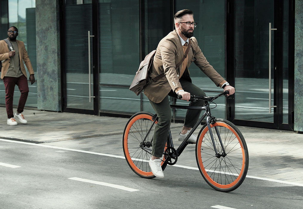 Man rides bike on road on way to work