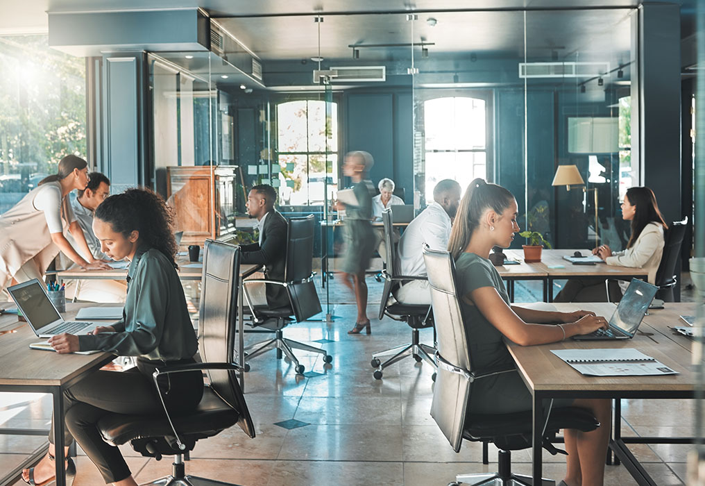 Several employees sit in a modern office